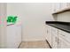 Bright laundry room with white cabinets and vinyl flooring at 772 N Swan Dr, Gilbert, AZ 85234