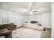 Bright living room with sectional sofa and ceiling fan at 772 N Swan Dr, Gilbert, AZ 85234