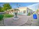 Landscaped backyard with brick pavers, fire pit, and covered patio at 772 N Swan Dr, Gilbert, AZ 85234
