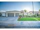 Single story home with two-car garage and well-manicured lawn at 772 N Swan Dr, Gilbert, AZ 85234