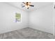 Well-lit bedroom with neutral walls and ceiling fan at 16205 W Berkeley Rd, Goodyear, AZ 85395