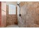 Walk-in shower with tiled walls and glass block window at 16205 W Berkeley Rd, Goodyear, AZ 85395