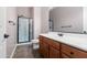 Bathroom with shower/tub combo and wood cabinets at 16205 W Berkeley Rd, Goodyear, AZ 85395