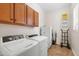 Laundry room with washer, dryer, and cabinets at 16205 W Berkeley Rd, Goodyear, AZ 85395