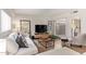 Living room with white couch, large TV, and patio access at 351 E Thomas Rd # D108, Phoenix, AZ 85012
