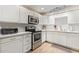 Modern kitchen with white cabinets and stainless steel appliances at 351 E Thomas Rd # D108, Phoenix, AZ 85012