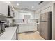 Modern kitchen with white cabinets, stainless steel appliances, and quartz countertops at 351 E Thomas Rd # D108, Phoenix, AZ 85012