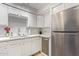 Kitchen with white cabinets, stainless steel appliances, and a corner sink at 351 E Thomas Rd # D108, Phoenix, AZ 85012