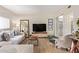 Living room with light colored sofa, armchair, and wood-look flooring at 351 E Thomas Rd # D108, Phoenix, AZ 85012