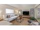 Living room with white couch and large TV at 351 E Thomas Rd # D108, Phoenix, AZ 85012