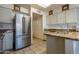 Kitchen boasts stainless steel refrigerator and granite countertops at 16715 E El Lago Blvd # 116, Fountain Hills, AZ 85268