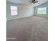 Large bedroom with ceiling fan and neutral carpeting at 17514 W Caribbean Ln, Surprise, AZ 85388