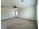 Bright bedroom with ceiling fan and neutral carpeting at 17514 W Caribbean Ln, Surprise, AZ 85388