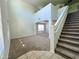 Bright and airy living room with high ceilings and a staircase at 17514 W Caribbean Ln, Surprise, AZ 85388