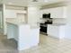 Kitchen with white cabinets, granite countertops, and a breakfast bar at 17514 W Caribbean Ln, Surprise, AZ 85388