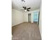 Bedroom with ceiling fan, carpet, and access to another room at 17514 W Caribbean Ln, Surprise, AZ 85388