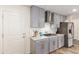 Kitchen boasts gray cabinets, marble countertops, and stainless steel range hood at 16245 W Culver St, Goodyear, AZ 85338