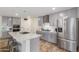 Spacious kitchen featuring gray cabinets, marble island, and wood flooring at 16245 W Culver St, Goodyear, AZ 85338