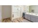 Bathroom features double vanity, gray cabinets, and a walk-in shower at 16245 W Culver St, Goodyear, AZ 85338
