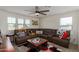 Relaxing loft space with sectional sofa, coffee table, and ceiling fan at 16245 W Culver St, Goodyear, AZ 85338