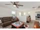 Open loft with a sectional sofa, coffee table, and access to bedroom at 16245 W Culver St, Goodyear, AZ 85338