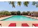 Community pool with red lounge chairs at 16245 W Culver St, Goodyear, AZ 85338