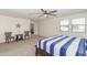 Comfortable bedroom with carpeted floor, ceiling fan, and seating area at 16245 W Culver St, Goodyear, AZ 85338