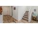 Carpeted staircase with a light-toned wood handrail, adding charm and functionality at 16245 W Culver St, Goodyear, AZ 85338