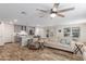 Spacious living room with beige couch, wood flooring, and ceiling fan at 16245 W Culver St, Goodyear, AZ 85338