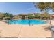 Community swimming pool with lounge chairs and patio at 16245 W Culver St, Goodyear, AZ 85338