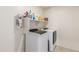 Well-equipped laundry room with washer, dryer, and shelving at 16245 W Culver St, Goodyear, AZ 85338