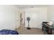 Bedroom with a desk, fan, and access to laundry room at 16245 W Culver St, Goodyear, AZ 85338
