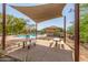 Community pool with shaded seating and picnic tables at 16245 W Culver St, Goodyear, AZ 85338