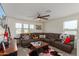 Bright and airy loft with a sectional sofa, coffee table, and large TV at 16245 W Culver St, Goodyear, AZ 85338