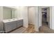 Bathroom with double sinks,walk-in closet, and grey cabinets at 16245 W Culver St, Goodyear, AZ 85338