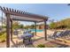 Community pool with pergola and lounge chairs at 16245 W Culver St, Goodyear, AZ 85338