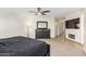 Main bedroom with a large TV, fireplace, and dresser at 45737 W Ranch Rd, Maricopa, AZ 85139