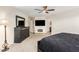 Main bedroom with a large TV, fireplace, and dresser at 45737 W Ranch Rd, Maricopa, AZ 85139