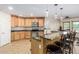 Spacious kitchen with granite countertops, stainless steel appliances, and an island with seating at 45737 W Ranch Rd, Maricopa, AZ 85139