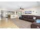 Open living space with a sectional sofa and views into a game room at 45737 W Ranch Rd, Maricopa, AZ 85139