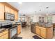 Open kitchen boasts granite counters, stainless steel appliances, and an island at 45737 W Ranch Rd, Maricopa, AZ 85139