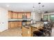 Spacious kitchen with granite countertops, stainless steel appliances, and an island with seating at 45737 W Ranch Rd, Maricopa, AZ 85139