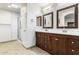 Bathroom with double vanity, large mirror, and shower at 45737 W Ranch Rd, Maricopa, AZ 85139