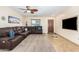 Spacious living room with a large sectional sofa and built-in entertainment center at 45737 W Ranch Rd, Maricopa, AZ 85139