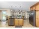 Open kitchen with island, granite counters and stainless steel appliances at 45737 W Ranch Rd, Maricopa, AZ 85139