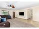 Spacious living room with a large sectional sofa and built-in entertainment center at 45737 W Ranch Rd, Maricopa, AZ 85139