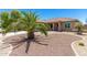 Single-story home with desert landscaping and a palm tree at 45737 W Ranch Rd, Maricopa, AZ 85139