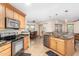 Open kitchen with granite counters, stainless steel appliances, and an island at 45737 W Ranch Rd, Maricopa, AZ 85139