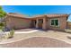 Well-maintained exterior with neutral color scheme and a desert landscape at 45737 W Ranch Rd, Maricopa, AZ 85139