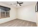 Bright bedroom with carpeted floor, ceiling fan, and window coverings at 45737 W Ranch Rd, Maricopa, AZ 85139